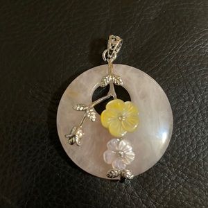 A Beautiful natural rose quartz flowers carved shell gemstone pendant.